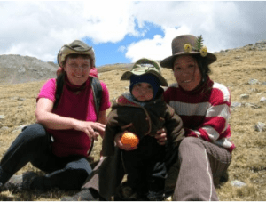 Thomas shares her lunch with a Peruvian shepherdess and her young child, high in the Cordilleras Huayhuash mountain range in the Andes