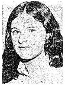 Close up of a young woman's face, smiling enigmatically