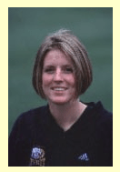 Head and shoulders of a young woman with bobbed hair in a black soccer jersey