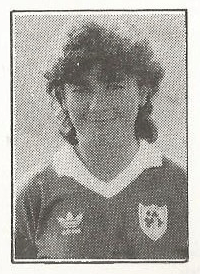 Black and white image of the head and upper torso of a smiling woman with dark, shoulder-length hair wearing a Republic of Ireland football jersey